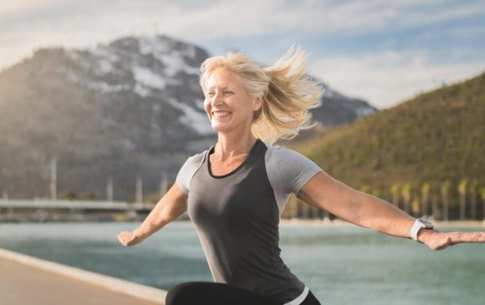 Happy woman celebrating her life-changing journey with CER Bariatrics